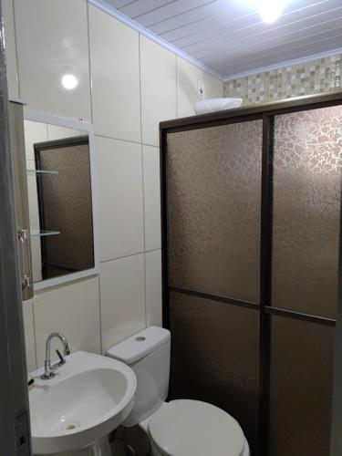 a bathroom with a toilet and a sink and a shower at Espaço aconchegante ótima localização in Foz do Iguaçu