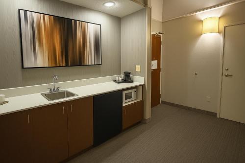 a kitchen with a sink and a counter top at Courtyard El Paso Airport in El Paso
