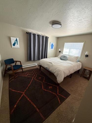 a bedroom with a large bed and a window at Miller Cabin in McCall