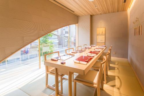 a long table in a room with a large window at Royal Park Hotel Takamatsu in Takamatsu