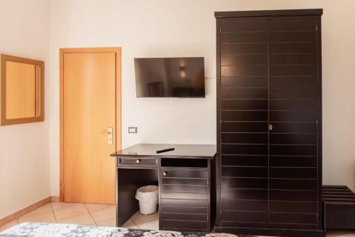 a bathroom with a black cabinet and a desk at Hotel Rossi in Manciano