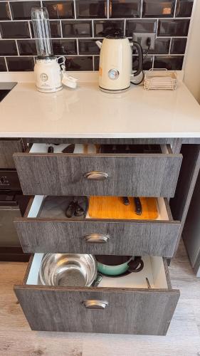 a kitchen with a counter with drawers at Getaway in Valparaiso in Valparaíso