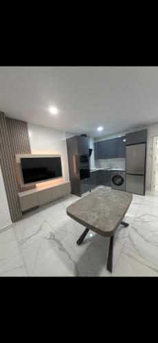a large kitchen with a table in the middle of it at Apartamento alhelí 2 in Barbate