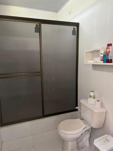 a bathroom with a toilet and a shower stall at Finca el milagro Melgar in Melgar