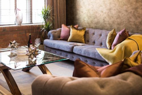 a living room with a couch and a glass table at Serenity Inn the City in York
