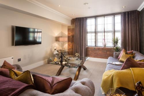 a living room with a couch and a table at Serenity Inn the City in York