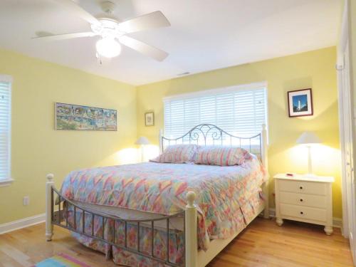 a bedroom with a bed and a ceiling fan at Cedar Cottage in Cape May Point
