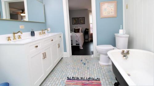 a bathroom with a sink and a tub and a toilet at Cottage At 37 Jackson in Cape May