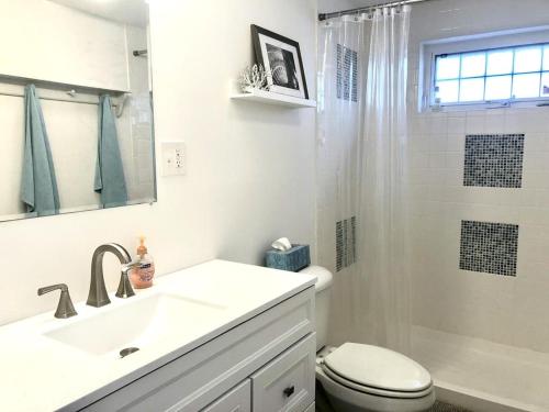 a bathroom with a sink and a toilet and a shower at Ocean Block Wifi Beach Badges Ship Bottom in Ship Bottom