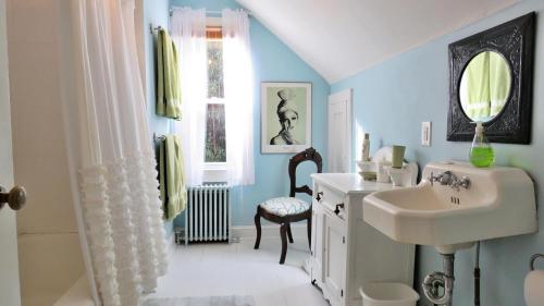 a bathroom with a sink and a toilet and a mirror at 637 Seagrove in Cape May Point