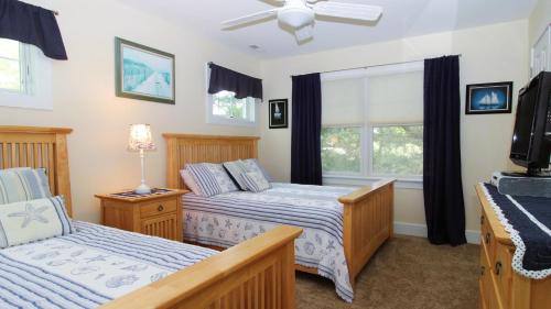 a bedroom with two beds and a tv at 320 Knox Avenue, Cape May Point in Cape May Point