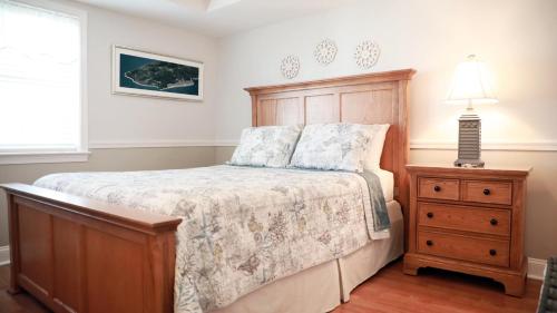 a bedroom with a bed and a dresser and a lamp at Broadway Beach Getaway Unit 2 in Cape May