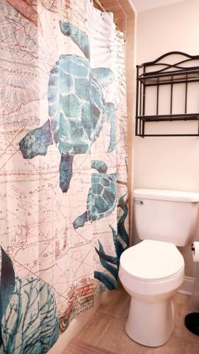 a bathroom with a toilet and a wall at Broadway Beach Getaway Unit 2 in Cape May