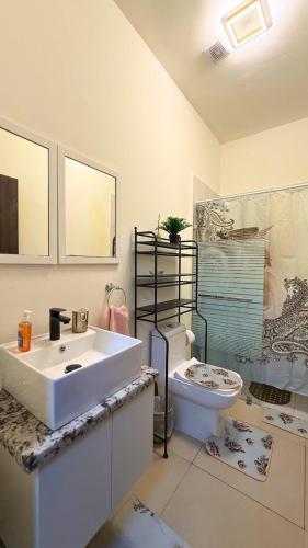 a bathroom with a white sink and a toilet at Cozy 1 bedroom in Punta Cana
