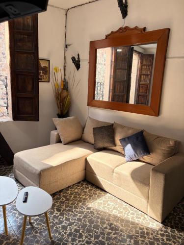 a living room with a couch and a mirror at Casa Paloma Querida in Taxco de Alarcón