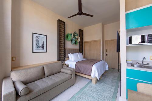 a hotel room with a bed and a couch at Casa Filomeno in Mexico City