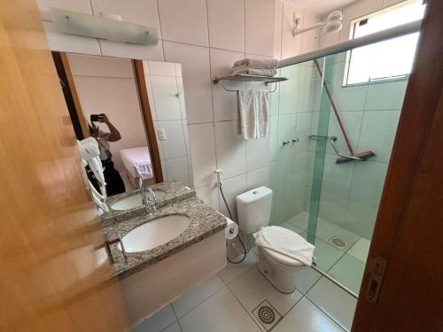a bathroom with a sink and a toilet and a shower at Flat in Caldas Novas in Caldas Novas