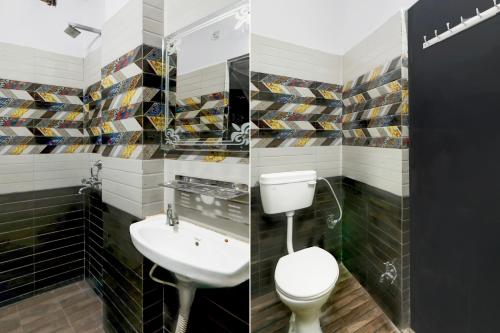a bathroom with a toilet and a sink at Super OYO Hotel O Indira Nagar in Lucknow