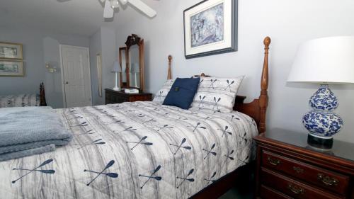 a bedroom with a bed with a blue and white comforter at Life S A Beach in Cape May