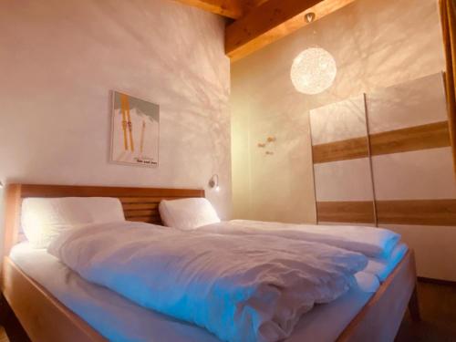 a bedroom with a large bed with blue sheets at Emma Top 4 in Dienten am Hochkönig
