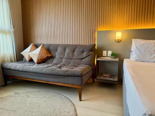 a living room with a couch with pillows on it at Hotel Bourbon - Quarto 1603 - Beira Mar de Fortaleza - Vista Mar in Fortaleza