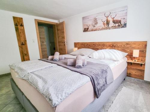 a bedroom with a large bed with pink and white pillows at Am Inn Fluss in Langkampfen