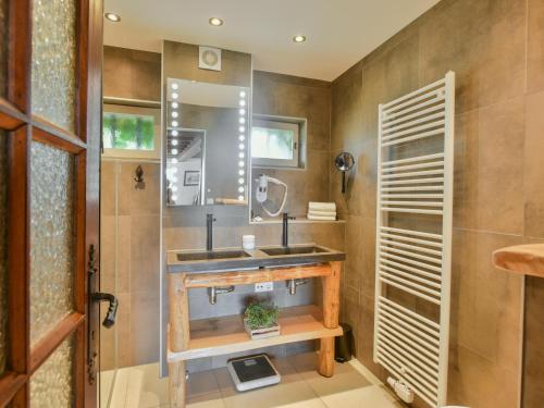 a bathroom with a sink and a mirror at Lusignac Maswari in Lusignac