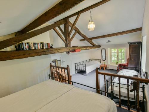 a bedroom with a bed in a room with wooden beams at Lusignac Maswari in Lusignac