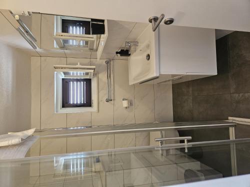 a kitchen with a glass counter top in a room at Apartments and rooms with a swimming pool Brist, Makarska - 15620 in Brist