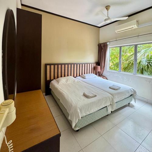 a bedroom with a bed and a large window at Gold Coast Morib Apartment in Banting