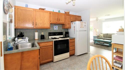 a kitchen with wooden cabinets and a white refrigerator at 12 Mechanic St in West Cape May