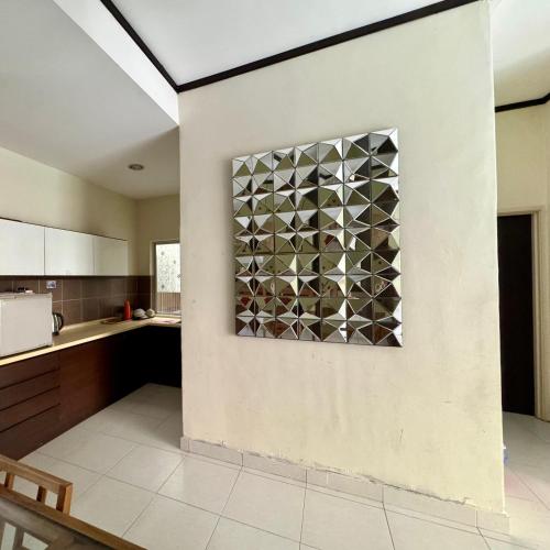 a kitchen with a wall with a metal grate at Gold Coast Morib Apartment in Banting