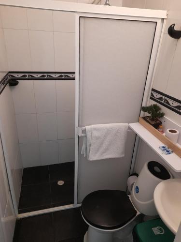 a bathroom with a shower with a toilet and a sink at Hostal Casa de las Americas in Cartagena de Indias