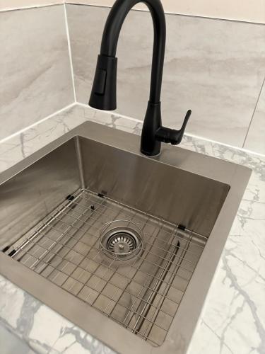 a sink with a faucet in a kitchen at Slumber Lodge in Hope