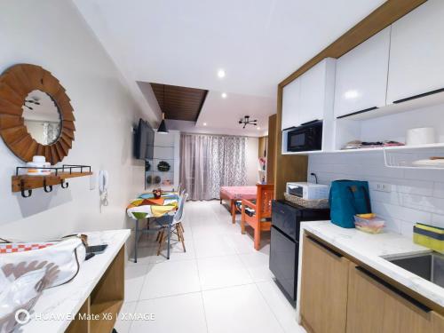 a kitchen with a counter and a dining room at Suntrust88 Tower1-Unit 4Y in Baguio