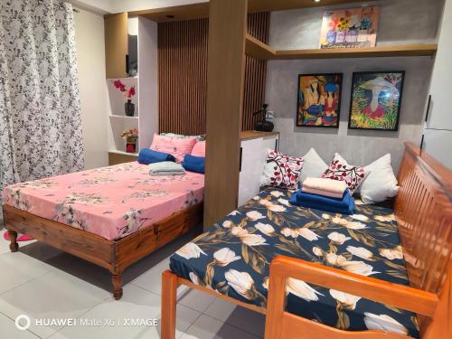 a small bedroom with a bed and a bed and a bedskirts at Suntrust88 Tower1-Unit 4Y in Baguio