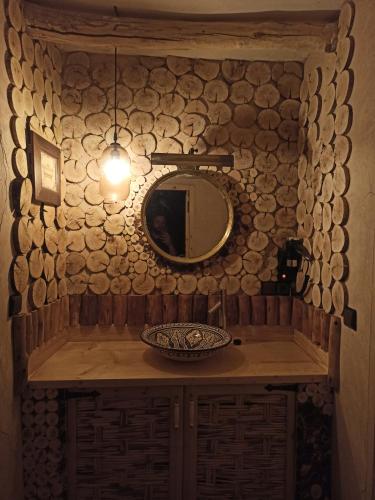 a bathroom with a counter with a mirror and a sink at Trésors des Ancêtres in Ibrahene