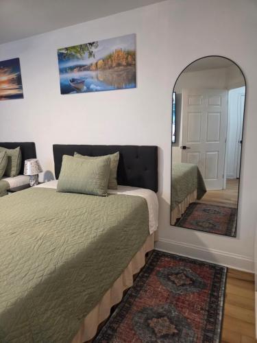 a bedroom with a bed and a mirror at Brooklyn Luxury Suite in Brooklyn