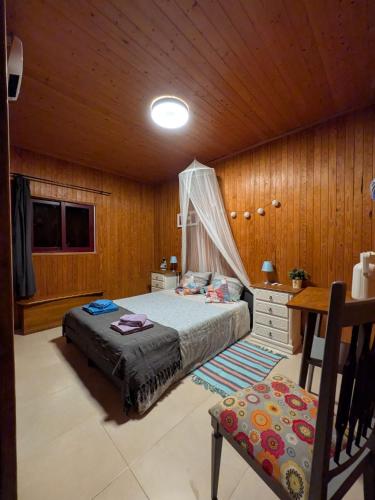 a bedroom with a bed and a wooden ceiling at Herdade da Hera in Azambuja