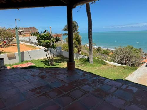a view of the ocean from the porch of a house at Casa bela vista in Icapuí