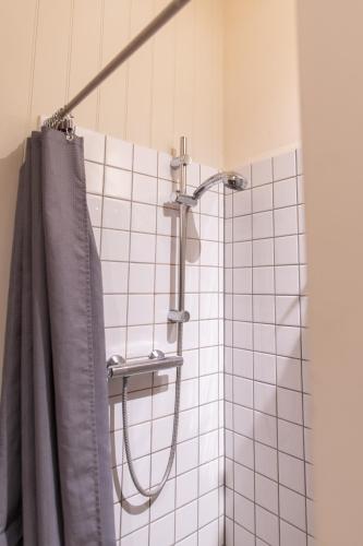 a shower with a shower curtain in a bathroom at sika lodge in Wareham