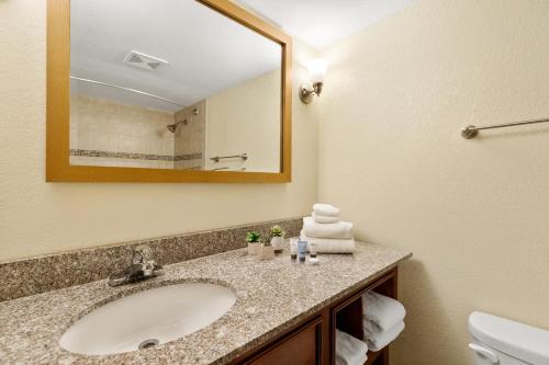 a bathroom with a sink and a mirror at Lakeside Inn in Wakefield