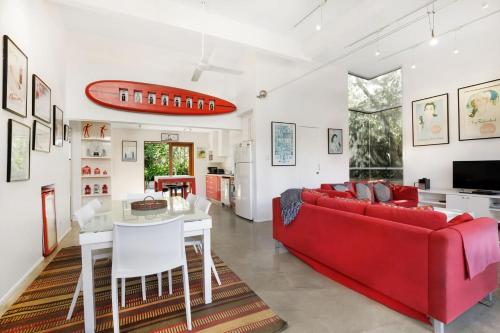 a living room with a red couch and a table at A AAA Coke Shack in Point Lookout