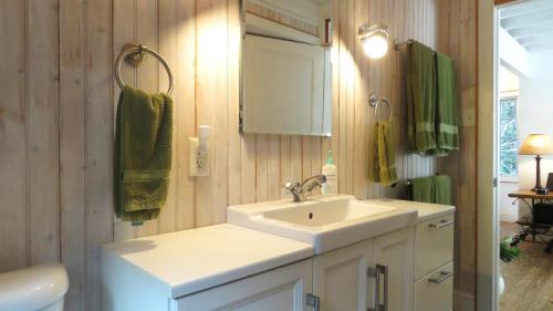 a white bathroom with a sink and a mirror at 639 Seagrove in Cape May Point