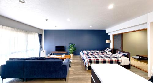 a hotel room with two beds and a couch at Blu Mare in Ō-shima