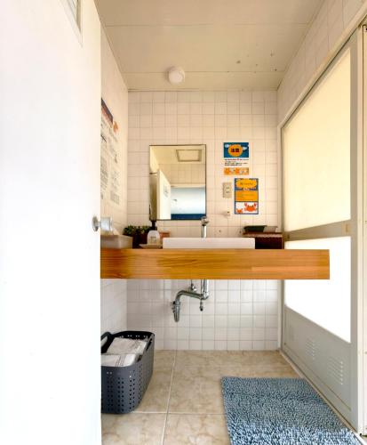 a bathroom with a sink and a mirror at Blu Mare in Ō-shima