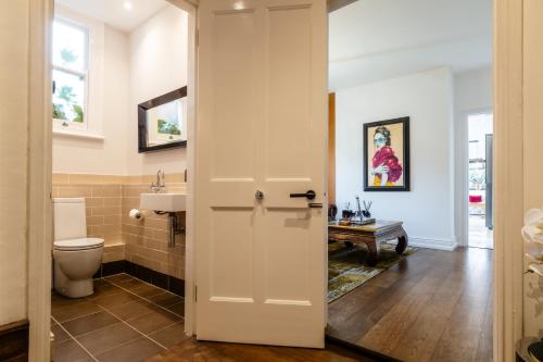 a bathroom with a toilet and a sink at Beautiful 5 Bedroom Home in Evesham in Evesham
