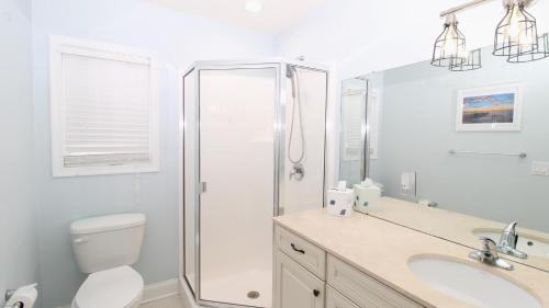 a bathroom with a shower and a toilet and a sink at 717 Broadway in West Cape May