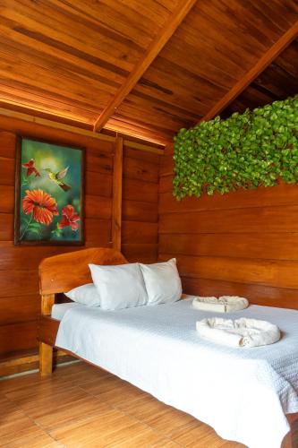 a bedroom with two beds in a wooden room at Cabañas SyC in Fortuna