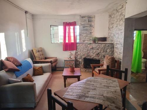 a living room with a couch and a fireplace at Don Ramón in Colonia del Sacramento